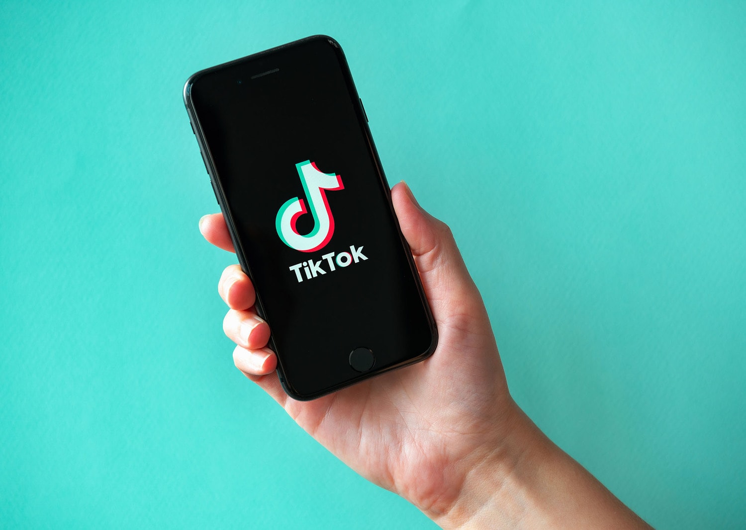 TikTok marketing - hand holding a phone with TikTok on it